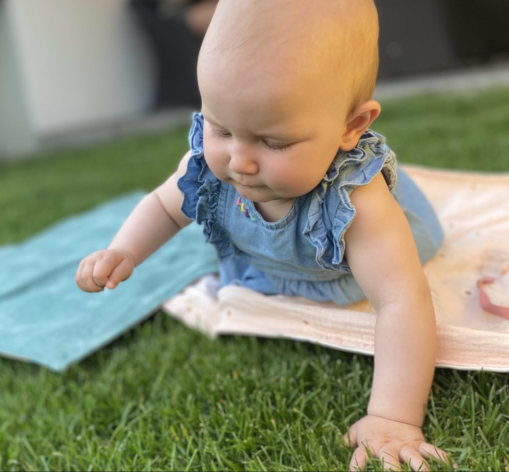 baby crawling on grass