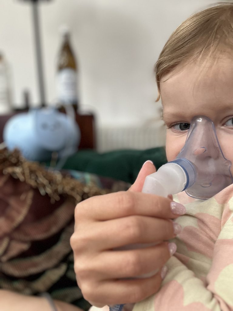 a baby with inhalator