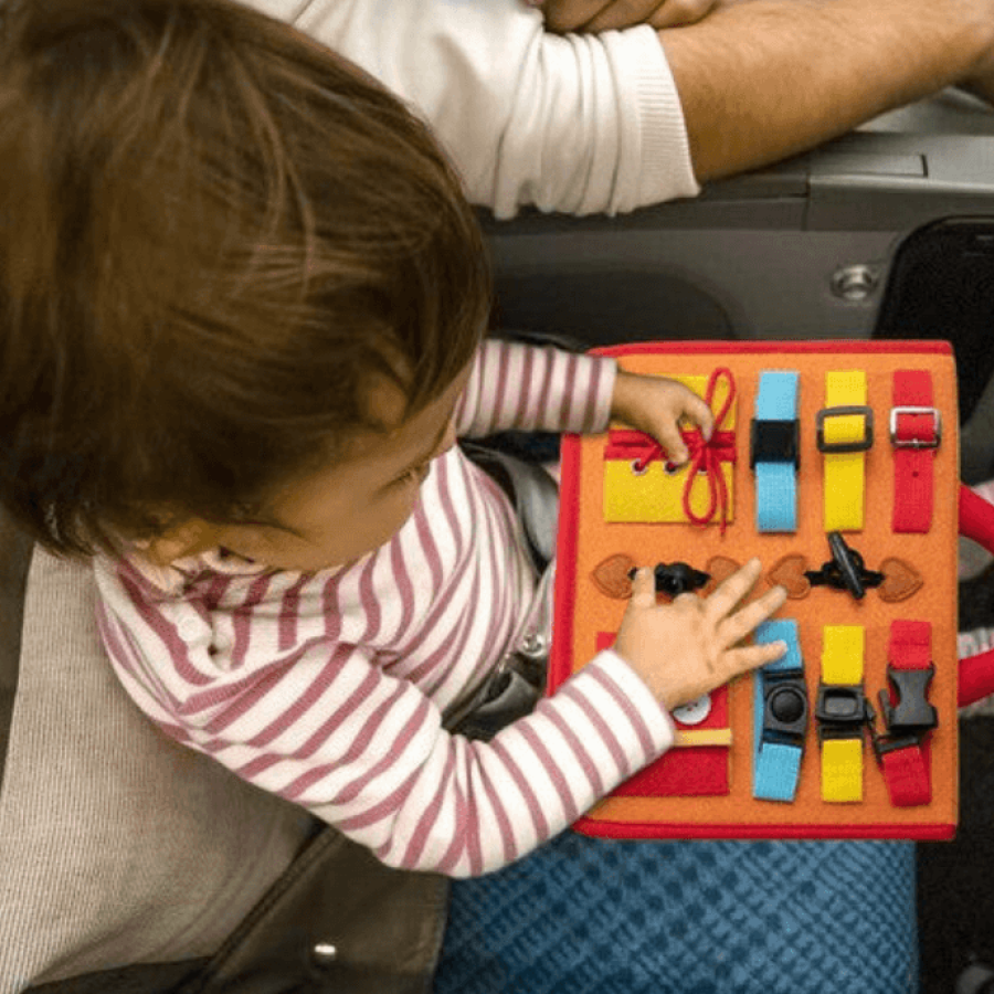 Baby playing with busy board